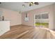 Bright living room featuring wood-look floors and sliding glass doors to the backyard at 568 Shoreham Ne Ct, St Petersburg, FL 33716