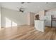Open-concept living space with hardwood floors, a ceiling fan, and natural light at 568 Shoreham Ne Ct, St Petersburg, FL 33716