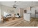 Cozy living room with hardwood floors, sofa, area rug, and eat-in kitchen at 568 Shoreham Ne Ct, St Petersburg, FL 33716