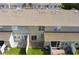 Rear view of the townhomes shows back patios and grassy yards at 568 Shoreham Ne Ct, St Petersburg, FL 33716