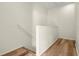 Staircase with wood-look floors and white railing leading upstairs at 568 Shoreham Ne Ct, St Petersburg, FL 33716