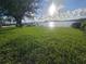 Lush green backyard leading to a waterfront with a private dock at 5688 Oakhurst Dr, Seminole, FL 33772