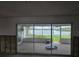 Enclosed patio with sliding glass doors overlooking a serene water view at 5688 Oakhurst Dr, Seminole, FL 33772