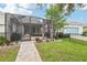 An open-air patio with seating and an outdoor grill with a nice backyard that is enclosed by a fence at 6005 Shell Ridge Dr, Lithia, FL 33547