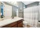 Neutral bathroom with a single vanity and a shower/tub combo with striped curtain at 6005 Shell Ridge Dr, Lithia, FL 33547
