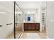 Elegant bathroom featuring a walk-in shower with a glass door and a double vanity at 6005 Shell Ridge Dr, Lithia, FL 33547