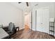 Light-filled bedroom featuring wood floors, closet, and neutral paint at 6005 Shell Ridge Dr, Lithia, FL 33547