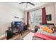 Comfortable bedroom with wood floors, a ceiling fan, and a window offering natural light at 6005 Shell Ridge Dr, Lithia, FL 33547
