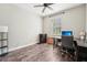 Functional bedroom with wood floors, a ceiling fan, and a large window at 6005 Shell Ridge Dr, Lithia, FL 33547