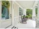 Inviting front porch with stone accents, seating, and view of well-manicured landscaping at 6005 Shell Ridge Dr, Lithia, FL 33547
