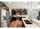 Well-equipped kitchen with stainless steel appliances, dark cabinetry, and quartz countertops at 6005 Shell Ridge Dr, Lithia, FL 33547