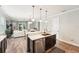 Open-concept kitchen with stainless steel appliances, dark cabinets, and view into living space at 6005 Shell Ridge Dr, Lithia, FL 33547