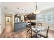 Modern kitchen and dining area with stainless steel appliances, dark cabinets, and wood floors at 6005 Shell Ridge Dr, Lithia, FL 33547