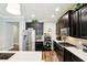 Stylish kitchen featuring stainless steel appliances, dark cabinetry, and ample counter space at 6005 Shell Ridge Dr, Lithia, FL 33547