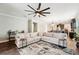 Large living area with a comfortable sectional sofa, large rug, and view of the kitchen at 6005 Shell Ridge Dr, Lithia, FL 33547