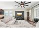 Comfortable living room with gray sofa, large windows, and a stylish entertainment center at 6005 Shell Ridge Dr, Lithia, FL 33547
