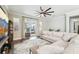 Open living area with sliding glass doors leading to the patio and a modern ceiling fan at 6005 Shell Ridge Dr, Lithia, FL 33547