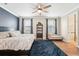 Serene main bedroom with a navy accent wall, plush rug, and natural light from two windows at 6005 Shell Ridge Dr, Lithia, FL 33547