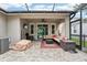 Inviting covered patio with stylish furniture, ceiling fan, and outdoor TV for relaxing and entertaining at 6005 Shell Ridge Dr, Lithia, FL 33547