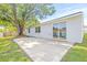 Backyard with a concrete patio, mature trees, and a well-maintained lawn at 6404 Monterey Blvd, Tampa, FL 33625