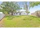 Expansive backyard with lush green grass, mature trees, and a privacy fence, ideal for outdoor activities at 6404 Monterey Blvd, Tampa, FL 33625