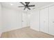 This bedroom features wood-look floors, a modern ceiling fan, and double closets for ample storage at 6404 Monterey Blvd, Tampa, FL 33625