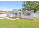 Charming home featuring a well-manicured lawn, an attached garage, and an arched front entryway at 6404 Monterey Blvd, Tampa, FL 33625