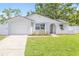 Charming single-story home with a well-manicured lawn, neutral tones, and an attached single-car garage at 6404 Monterey Blvd, Tampa, FL 33625