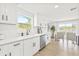 Bright kitchen with white countertops, stainless steel dishwasher, and views of the backyard at 6404 Monterey Blvd, Tampa, FL 33625