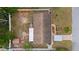 Aerial view of the property showcasing the roof, yard, fire pit, and surrounding landscaping on a sunny day at 6698 35Th N Ave, St Petersburg, FL 33710