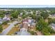 Aerial view of a residential area featuring a home with a fire pit, lush trees, neighboring houses, and local streets at 6698 35Th N Ave, St Petersburg, FL 33710