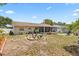 Open backyard features a fire pit and chairs, landscaping, and a screened in patio at 6698 35Th N Ave, St Petersburg, FL 33710