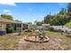 Open backyard featuring a fire pit, comfortable outdoor seating, and a utility shed at 6698 35Th N Ave, St Petersburg, FL 33710