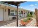 Inviting front porch with rocking chairs and hanging plants, complemented by a brick walkway and well-maintained landscaping at 6698 35Th N Ave, St Petersburg, FL 33710