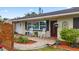 Inviting front porch with brick pavers, rocking chairs, and a decorative front door at 6698 35Th N Ave, St Petersburg, FL 33710