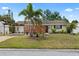 Charming single-story home with mature landscaping, a covered carport, and a welcoming front yard at 6698 35Th N Ave, St Petersburg, FL 33710