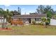 Charming single-story home with a well-manicured front yard, adorned with lush tropical landscaping and a cozy patio area at 6698 35Th N Ave, St Petersburg, FL 33710