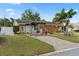 Well maintained front yard with palm trees, rock landscaping, and a covered drive at 6698 35Th N Ave, St Petersburg, FL 33710