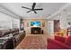 Bright living room with decorative brick accent wall, wood-look flooring, and ceiling fan at 6698 35Th N Ave, St Petersburg, FL 33710