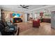 Open-concept living room with wood floors, stone accent wall, and modern furnishings at 6698 35Th N Ave, St Petersburg, FL 33710