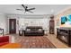 Well-lit living room with wood floors, an electric fireplace, and a view of the front door at 6698 35Th N Ave, St Petersburg, FL 33710