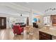 Spacious living area with wood floors, a stone accent wall, and open layout to the kitchen at 6698 35Th N Ave, St Petersburg, FL 33710