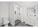 Updated bathroom features a walk-in shower with black and white tile and a modern vanity at 7 Hamilton Heath Dr, Tampa, FL 33604