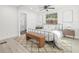 Well-lit bedroom with ceiling fan, rug, and view of the bathroom at 7 Hamilton Heath Dr, Tampa, FL 33604