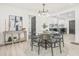 Dining area featuring a contemporary glass table with seating for six and a modern chandelier above at 7 Hamilton Heath Dr, Tampa, FL 33604