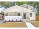 Charming renovated two-story home featuring a covered porch, black door, fresh landscaping and newly poured concrete steps at 7 Hamilton Heath Dr, Tampa, FL 33604