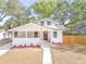 Charming home featuring a modern front porch, a new front entrance, and manicured landscaping at 7 Hamilton Heath Dr, Tampa, FL 33604