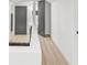 Hallway with neutral walls and light hardwood flooring at 7 Hamilton Heath Dr, Tampa, FL 33604
