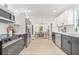 Spacious kitchen with stainless steel appliances, white cabinets, and light hardwood floors at 7 Hamilton Heath Dr, Tampa, FL 33604