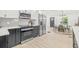 Bright eat-in kitchen features stainless appliances, light hardwood floors, and access to the dining room at 7 Hamilton Heath Dr, Tampa, FL 33604